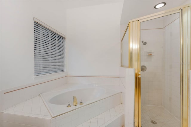 bathroom featuring separate shower and tub