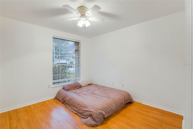 bedroom with hardwood / wood-style floors and ceiling fan