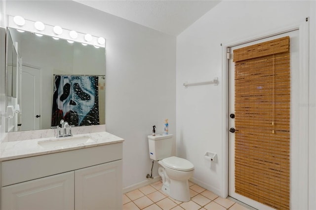 bathroom with toilet, vaulted ceiling, tile patterned flooring, a textured ceiling, and vanity