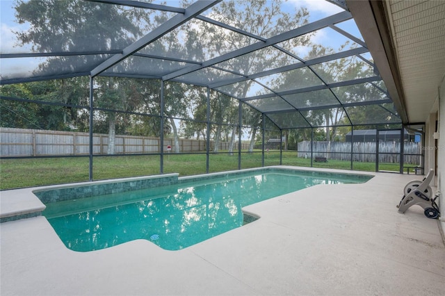 view of pool with glass enclosure, a patio area, and a lawn