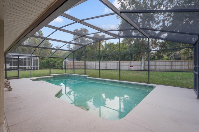 view of swimming pool with a lanai, a patio, and a yard