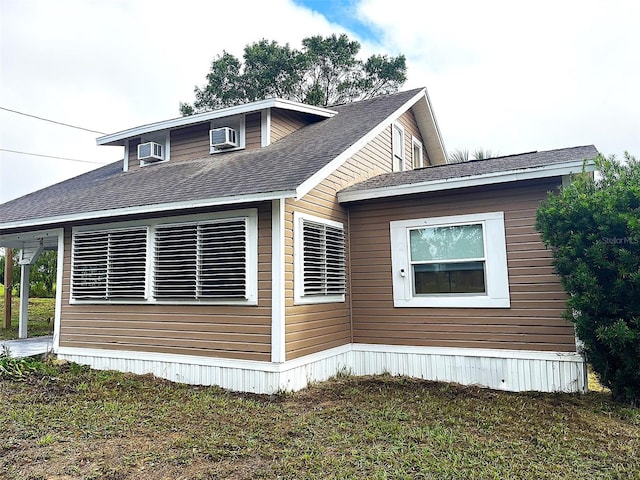 view of property exterior featuring a lawn and cooling unit