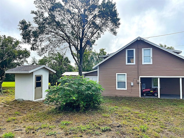 view of home's exterior with a shed and a lawn