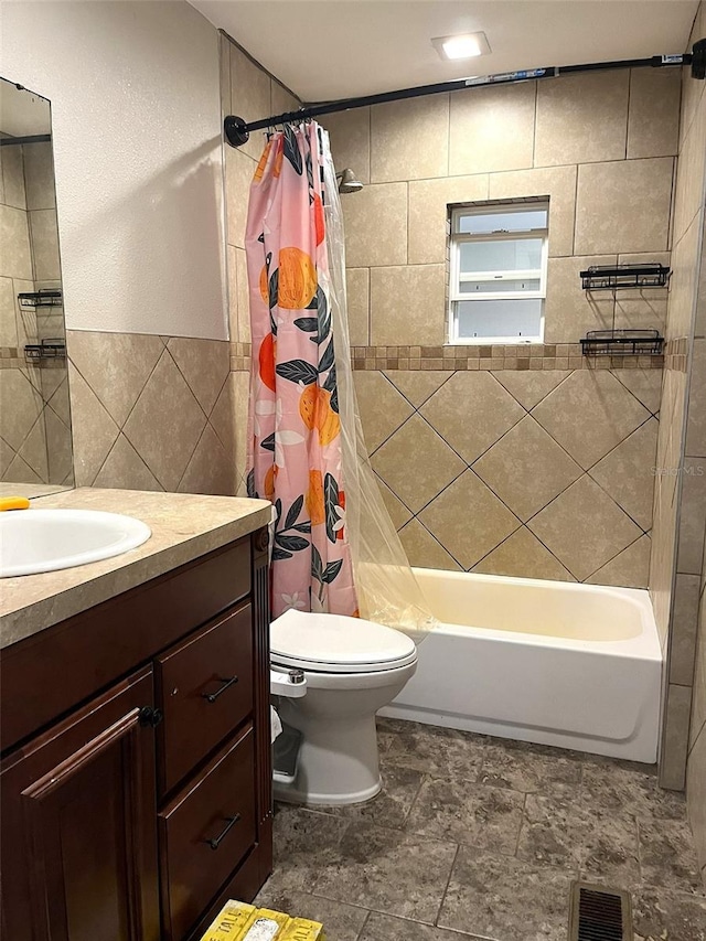 full bathroom with tile walls, vanity, shower / bath combination with curtain, and toilet