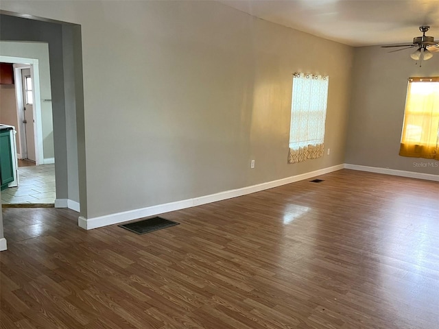 spare room with ceiling fan and dark hardwood / wood-style floors