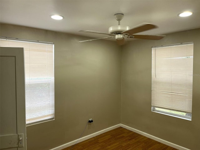 unfurnished room featuring dark hardwood / wood-style flooring and ceiling fan