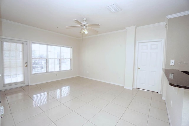 tiled empty room featuring ornamental molding and ceiling fan