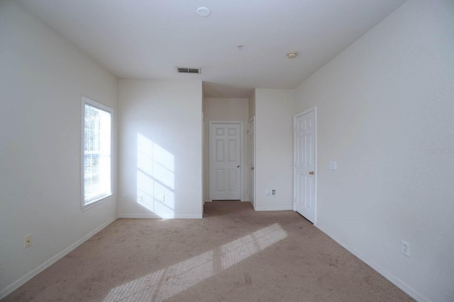 unfurnished room with light carpet