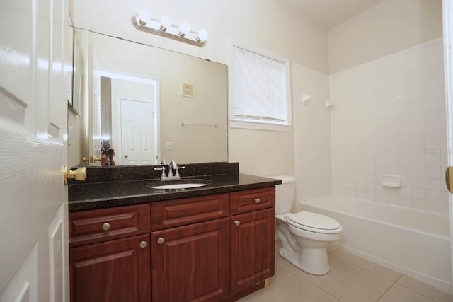 full bathroom featuring vanity, tile patterned flooring, toilet, and tiled shower / bath