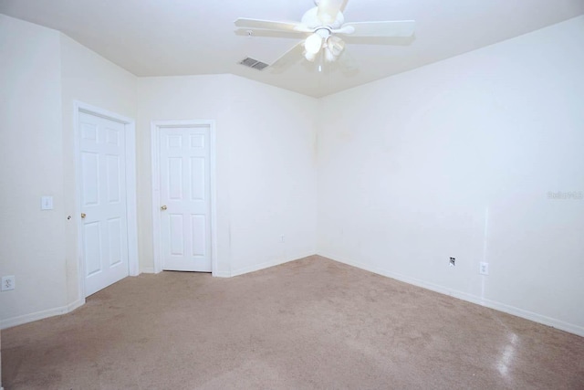 carpeted spare room featuring ceiling fan