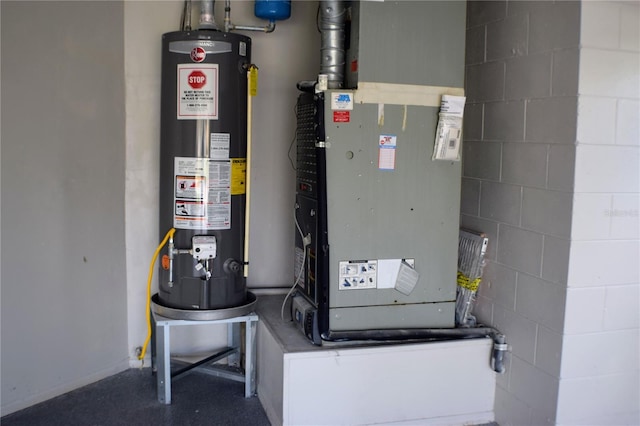 utility room featuring gas water heater and heating unit