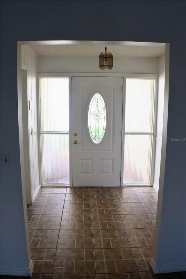 foyer with dark tile patterned flooring