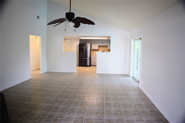 unfurnished living room featuring ceiling fan and high vaulted ceiling