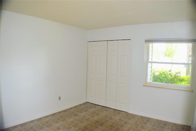 unfurnished bedroom with a closet