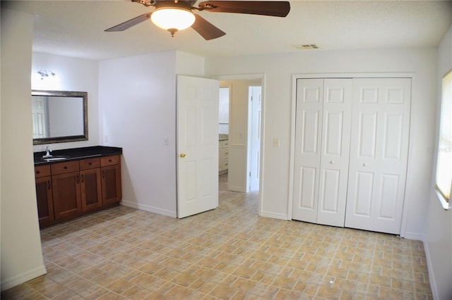 interior space featuring vanity and ceiling fan