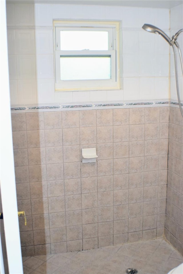 bathroom with a tile shower