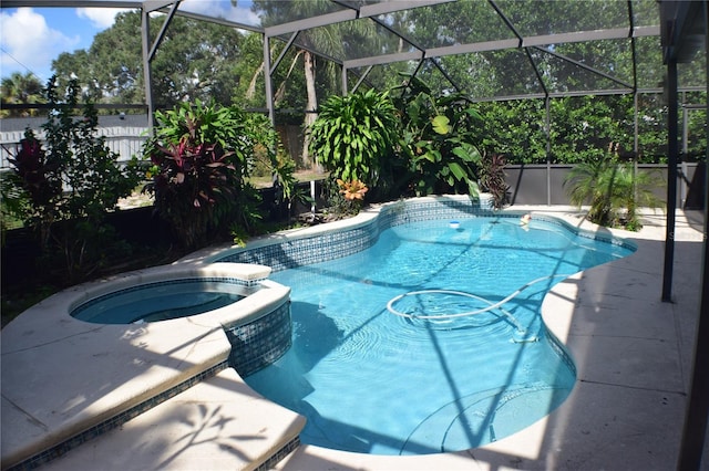 view of swimming pool with an in ground hot tub and a lanai