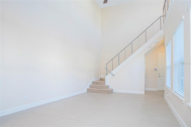 unfurnished living room featuring a high ceiling