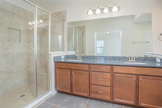 bathroom with vanity, tile patterned floors, and walk in shower