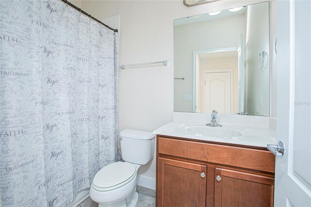 bathroom with tile patterned floors, vanity, and toilet