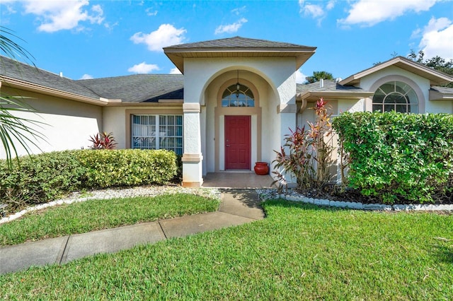 entrance to property with a yard