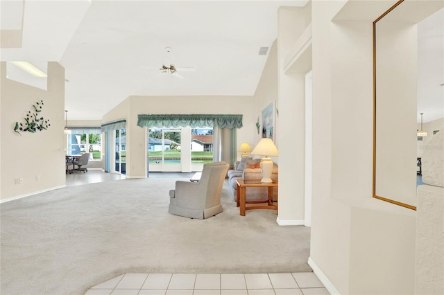 living room with ceiling fan, lofted ceiling, and light colored carpet