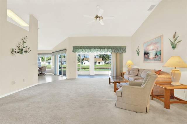 carpeted living room featuring ceiling fan, a healthy amount of sunlight, and high vaulted ceiling