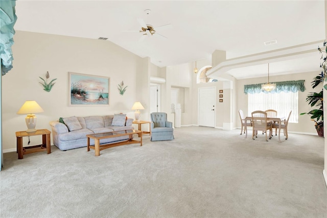 living room featuring carpet floors, lofted ceiling, and ceiling fan with notable chandelier