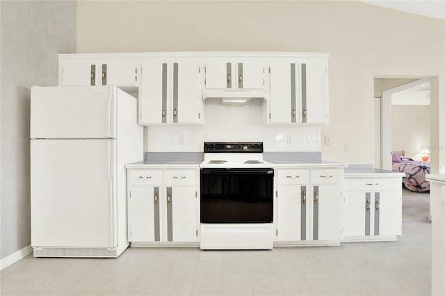 kitchen featuring white cabinetry, range with electric cooktop, and white fridge