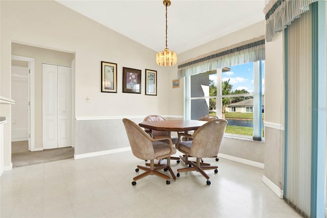 dining room with a chandelier and vaulted ceiling