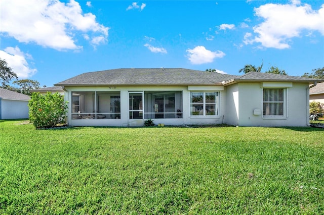 back of property with a sunroom and a lawn