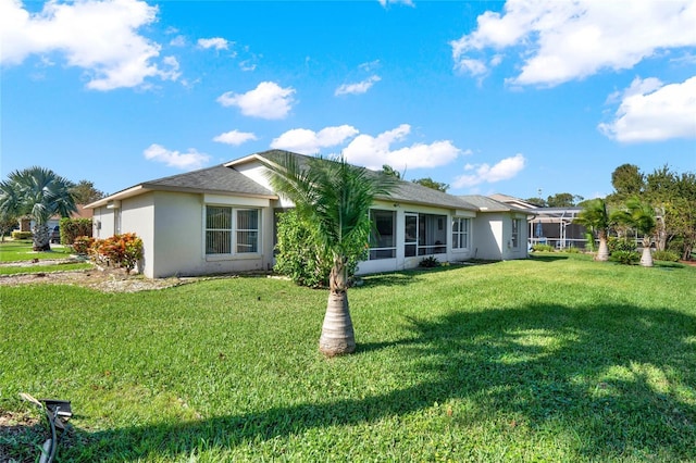 rear view of house with a lawn