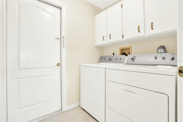 clothes washing area with cabinets, light tile patterned floors, and independent washer and dryer