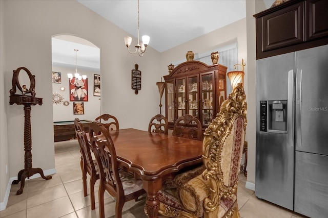 4001 Scarlet Branch Rd, Orlando, FL 32824 - dining space featuring a chandelier, light tile patterned floors, baseboards, vaulted ceiling, and arched walkways