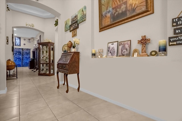 4001 Scarlet Branch Rd, Orlando, FL 32824 - corridor with arched walkways, baseboards, and light tile patterned floors