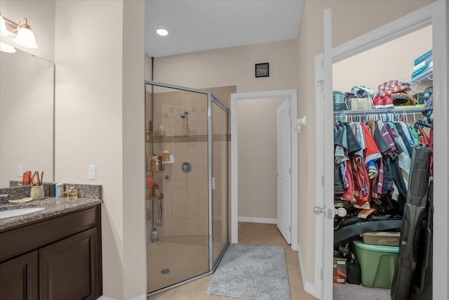 4001 Scarlet Branch Rd, Orlando, FL 32824 - full bathroom featuring a shower stall, a spacious closet, vanity, and tile patterned flooring