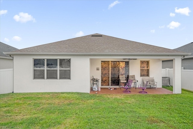 4001 Scarlet Branch Rd, Orlando, FL 32824 - back of property with a patio area, roof with shingles, a ceiling fan, and stucco siding