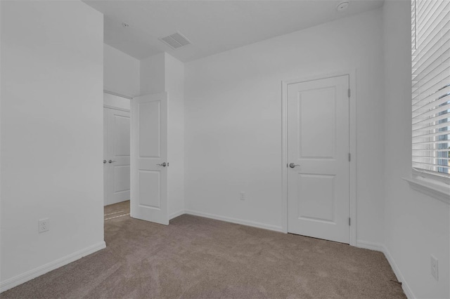 unfurnished bedroom with light colored carpet