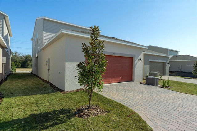 view of front facade with a front yard and central air condition unit