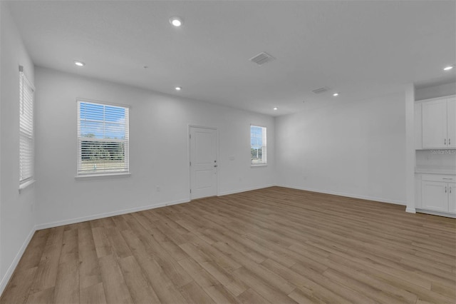 unfurnished living room with light hardwood / wood-style flooring