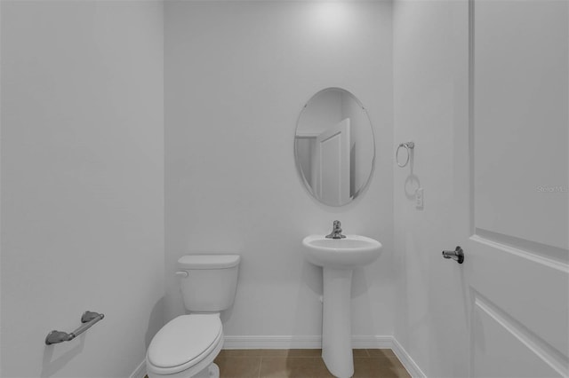 bathroom featuring tile patterned flooring and toilet