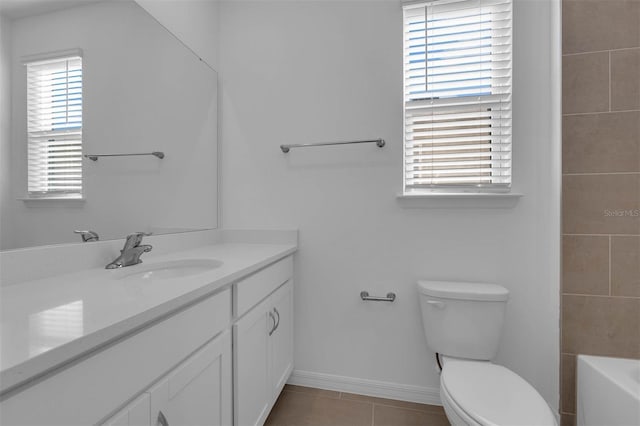 bathroom with vanity, toilet, and tile patterned flooring