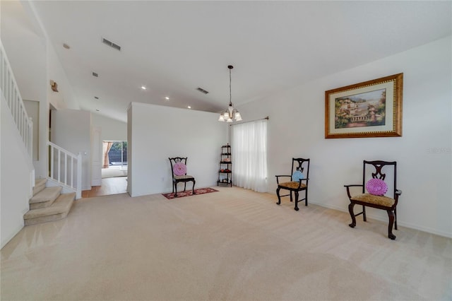 sitting room featuring light colored carpet, lofted ceiling, and an inviting chandelier