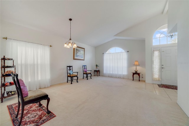 sitting room with light colored carpet, high vaulted ceiling, and a notable chandelier