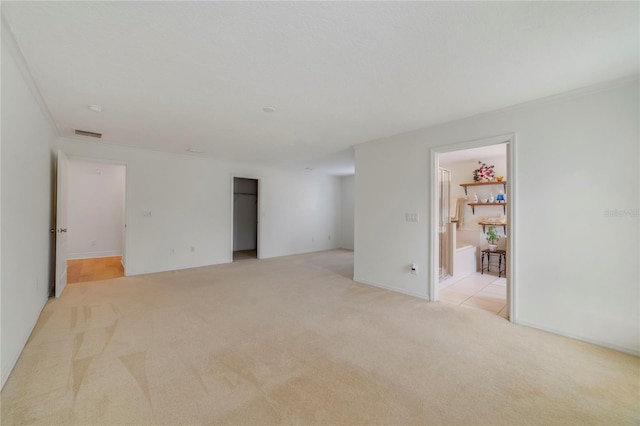 carpeted spare room featuring crown molding