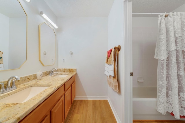 bathroom featuring vanity, shower / bath combination with curtain, and hardwood / wood-style flooring