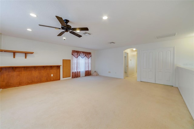 carpeted spare room featuring ceiling fan