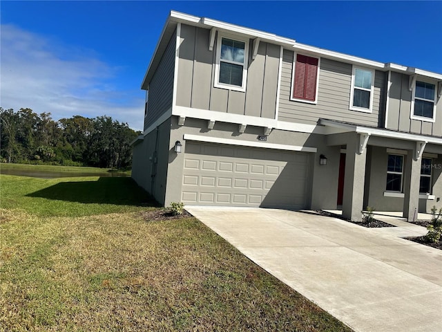 view of front facade with a garage and a front lawn