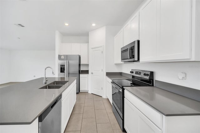 kitchen featuring light tile patterned floors, sink, an island with sink, white cabinetry, and appliances with stainless steel finishes