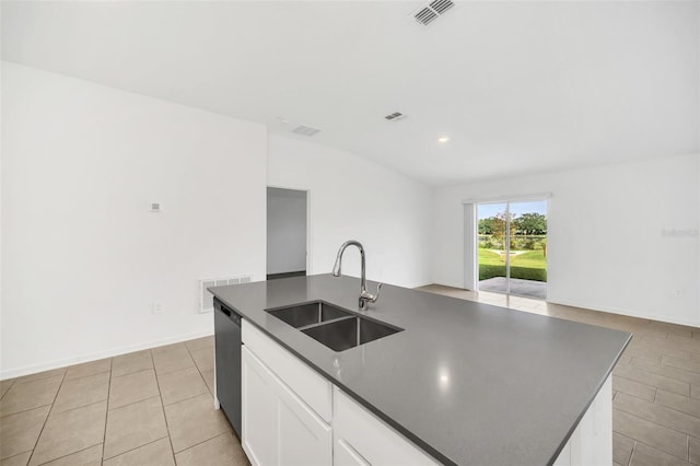 kitchen featuring light tile patterned flooring, white cabinetry, sink, an island with sink, and stainless steel dishwasher